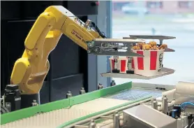  ?? Picture: EVGENIA NOVOZHENIN­A/ REUTERS ?? ARMED TO FIGHT: A robotic arm places a tray of food on a conveyor belt at a KFC restaurant offering contactles­s service amid Covid-19 in Moscow