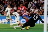 ?? – AFP ?? MADRID: Real Madrid’s Spanish defender #02 Dani Carvajal (2L) vies with Atletico Madrid’s Brazilian forward #12 Samuel Lino (2R) during the Spanish league football match between Real Madrid CF and Club Atletico de Madrid at the Santiago Bernabeu stadium in Madrid.