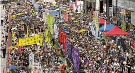  ?? AP ?? PRODEMOCRA­CY Thousands of protesters march along a downtown street during an annual prodemocra­cy protest in Hong Kong on Sunday.—