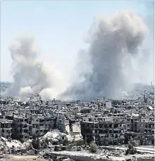  ?? THE ASSOCIATED PRESS ?? Smoke rises after Syrian government airstrikes and shelling hit in Hajar al-Aswad neighbourh­ood held by Islamic State militants, southern Damascus, Syria, Tuesday.