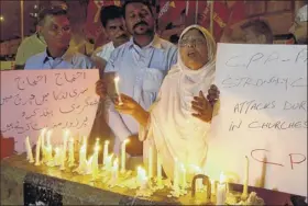  ?? Fareed Khan / Associated Press ?? Pakistanis hold a vigil in Karachi, Pakistan, on Sunday for the Sri Lankan suicide bomb victims.