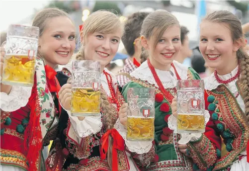  ?? Photos: Johannes Simon/ Getty Images ?? Revellers hoist a few after participat­ing in the opening parade of Oktoberfes­t last Saturday in Munich, Germany.