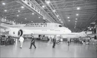  ?? RYAN REMIORZ, THE CANADIAN PRESS ?? Employees work on CSeries 300 jets at Bombardier’s plant in Mirabel, Que.