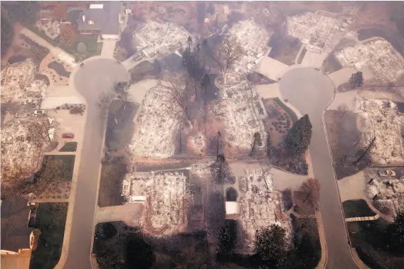  ?? Santiago Mejia / The Chronicle ?? Most structures along Melene Court (left) and Mountain Meadow Court in Paradise (Butte County) were destroyed in the Camp Fire, but two survived.