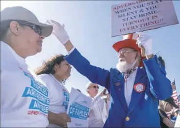  ?? Paul Ratje/AFP/Getty Images ?? Leon Blevins, dressed as Uncle Sam, salutes other attendees during the “End Family Detention” event held at the Tornillo Port of Entry in Tornillo, Texas, on Sunday.