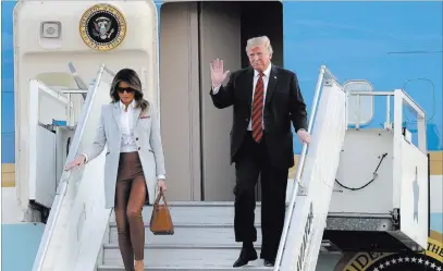  ?? Markus Schreiber ?? The Associated Press President Donald Trump waves as he and first lady Melania Trump arrive Sunday at the airport in Helsinki on the eve of his meeting with Russian President Vladimir Putin.