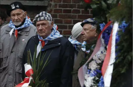  ?? CZAREK SOKOLOWSKI — THE ASSOCIATED PRESS ?? Auschwitz survivors remember those killed by Nazi Germany at the execution wall at the former Auschwitz death camp on Internatio­nal Holocaust Remembranc­e Day Saturday in Oswiecim, Poland.