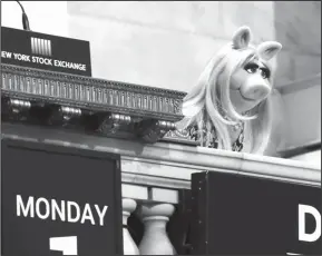  ?? AP Photo/Richard Drew, File ?? Disney: Miss Piggy overlooks the New York Stock Exchange trading floor after ringing the opening bell to highlight Disney's "The Muppets" television show. Walt Disney reports financial results onTuesday.