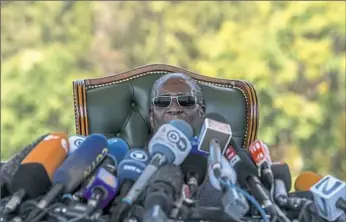  ??  ?? Former Zimbabwean President Robert Mugabe holds a press briefing Sunday at his residence in Harare on the eve of the country’s election. Zimbabwe votes Monday in an election that, if deemed credible, could tilt the country toward recovery after years...