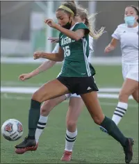  ?? KEN SWART — FOR MEDIANEWS GROUP ?? Annamarie Fosmoen (15) of Lake Orion moves past Birmingham Seaholm’s Sadie Green during the OAA White match-up played on Friday at Lake Orion High School. Fosmoen had a hat trick to help the Dragons earn a 5-2 win.