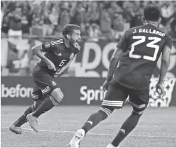  ??  ?? Mexico midfielder Jonathan Dos Santos (6) celebrates after scoring against the United States on Sunday in Chicago.