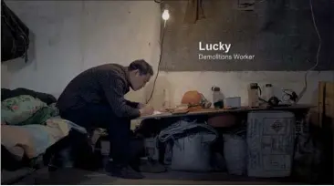  ??  ?? In a screenshot from Iron Moon, demolition worker Chen Nianxi (pen name Lucky) writes a letter to his son, who goes to school hundreds of miles away. Below left: a poster of the film.
