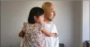  ?? THE NEW YORK TIMES ?? Takayuki Miyabe holds his daughter Karen, whose seizures from a rare form of epilepsy are treated with CBD oil, in Kobe, Japan, Sept. 25.