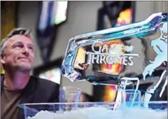  ?? AFP ?? A man sits near a ice sculpture in California.