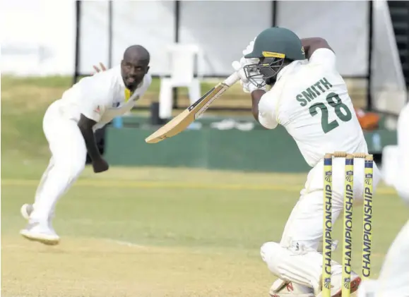  ?? (Photo: Observer file) ?? Windward Islands Volcanoes batsman Devon Smith (right) drives as Jamaica Scorpions pacer Derval Green looks on during a regional fourday match at Sabina Park in January 2020.