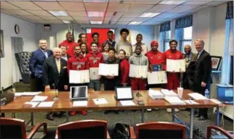  ?? CONTRIBUTE­D PHOTO ?? Members of the Trenton Central boys basketball team are presented with sealed certificat­es from the Mercer County Board of Chosen Freeholder­s to commemorat­e their Central Jersey Group IV sectional championsh­ip season.