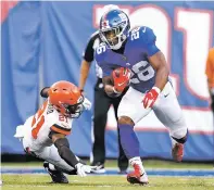  ?? ADAM HUNGER ASSOCIATED PRESS ?? The New York Giants’ Saquon Barkley rushes past the Browns’ Denzel Ward during the first half of a preseason NFL game Thursday in East Rutherford, N.J.