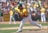  ?? Nhat V. Meyer / Bay Area News Group /TNS ?? Oakland Athletics'yusmeiro Petit (36) throws against the Boston Red Sox in the seventh inning on Sunday, April 22, 2018 at the Oakland Coliseum.