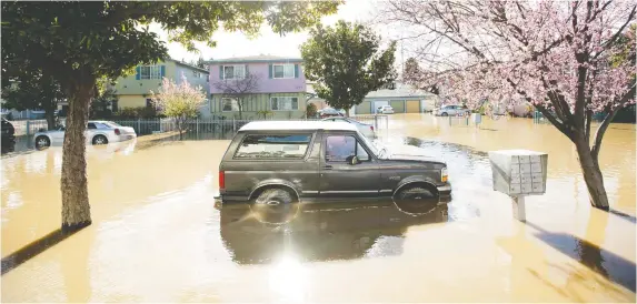  ?? NOAH BERGER/AFP VIA GETTY IMAGES FILES ?? Insiders say the UN's bleak assessment of climate change shows the need to move faster on environmen­tal, social and governance investment­s in the short-term and the urgency of tackling the climate challenge with a longer perspectiv­e. Above, the Rock Springs area of San Jose, Calif., is flooded after a storm in 2017.