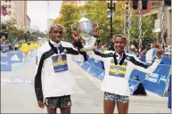  ?? Winslow Townson / Associated Press ?? Benson Kipruto, left, and Diana Kipyogei, both of Kenya, celebrate winning the men’s and women’s divisions of the 125th Boston Marathon on Monday in Boston.