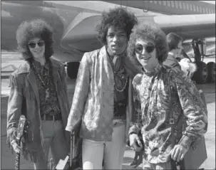  ?? The Associated Press ?? JIMI HENDRIX EXPERIENCE: This Aug. 21, 1967, file photo shows bass guitarist Noel Redding, left, guitarist Jimi Hendrix, center, and drummer Mitch Mitchell, of the Jimi Hendrix Experience, at Heathrow airport in London. 1967 saw many debuts, from...