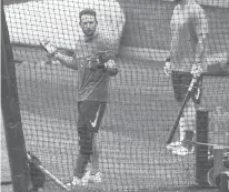  ?? KATHY WILLENS/AP ?? Wearing a brace on his left leg, Mets infielder Jed Lowrie, left, reacts after an at-bat during a summer training camp simulated game July 7 in New York.