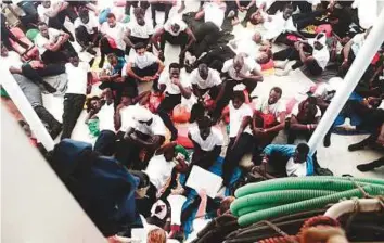  ?? AP ?? The suffering of stranded migrants aboard SOS Mediterran­ee’s Aquarius ship could last another three or four more days before they are finally able to land in Spain, officials say.