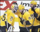  ?? Mark Zaleski The Associated Press ?? Nashville Predators forwards Calle Jarnkrok and Craig Smith (15) congratula­te goalie Pekka Rinne (35) after the team defeated the Penguins.