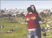  ?? JEFF CHIU — THE ASSOCIATED PRESS ?? Julie Rajagopal, facing, hugs her 16-year-old foster child from Eritrea after posing for photos at Dolores Park in San Francisco. When he landed in March, he was among the last refugee foster children to make it into the U.S.