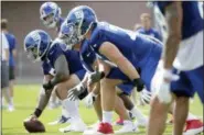  ?? JULIO CORTEZ — THE ASSOCIATED PRESS ?? Giants center Jon Halapio, left, prepares to snap the ball during recent training camp in East Rutherford, N.J.