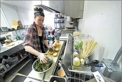  ?? NWA Democrat-Gazette/J.T. WAMPLER ?? Amber Cafourek-Belasco makes sandwiches at Natural State Sandwiches in downtown Springdale. The owners started the business in a food truck before moving into their current location on Emma Avenue.