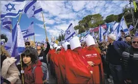  ?? Ohad Zwigenberg Associated Press ?? ISRAELIS PROTEST plans by Prime Minister Benjamin Netanyahu’s new government to overhaul the judicial system in Jerusalem on Feb. 13.