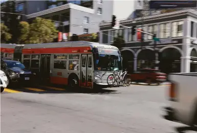  ?? Photos by Lea Suzuki / The Chronicle ?? A Muni bus moves in the lane for the Bus Rapid Transit system on Van Ness Avenue in San Francisco.