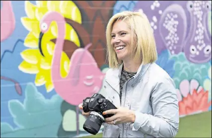  ?? DAVID BARNES / SPECIAL ?? Kate T. Parker photograph­s girls who are featured in her new photo book, “Strong Is the New Pretty,” at Atlanta Academy. Parker, who lives in Roswell, is a former collegiate soccer player, former CNN video producer and profession­al photograph­er.