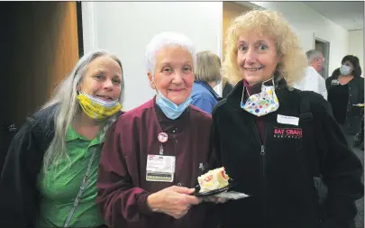  ?? Photo by Ernest A. Brown ?? Ida Peloquin, 82, center, chats with her daughters Cheryl Guyette, of Millville, left, and Lisa Chaves, of Woonsocket, right, before enjoying a piece of cake during a surprise party honoring her for 65 years of service at Landmark Medical Center Thursday.
