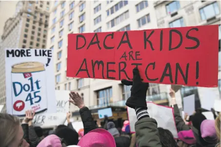  ?? Jeenah Moon / Bloomberg ?? A demonstrat­or holds a sign supporting “Dreamers” at Columbus Circle during Saturday’s Women’s March in New York City.