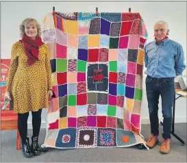  ?? (Pic: Marian Roche) ?? Pauline O’Grady Noonan and Brendan Scahill of the HSE, unveiling the ‘Covid Throw’ in Mitchelsto­wn Library earlier this week.