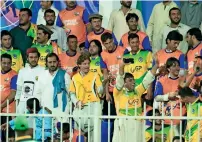  ??  ?? Fans of Bengal Tigers and Pakhtoons cheer on their respective teams during the T10 League match played at the Sharjah Cricket Stadium on Monday. —