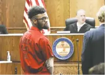  ?? STAFF PHOTO BY TIM BARBER ?? Judge Tom Greenholtz listens to the prosecutor in his courtroom Tuesday morning during a hearing held to set a trial date for D’Marcus White, at left, charged in the death of Mohammad Sharifi.