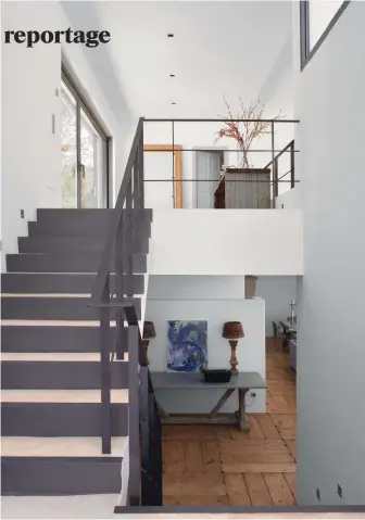  ??  ?? Avec sa rampe en métal, l’escalier moderne contraste dans un esprit indus’ avec l’authentici­té du parquet et du mobilier en bois.