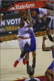  ?? TIM PHILLIS - THE NEWS-HERALD ?? Kyrie Irving drives to the basket during the first half of Game 4 of the NBA Finals against the Warriors on June 9.