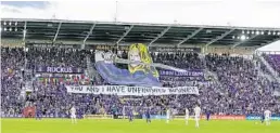  ?? DOUGLAS DEFELICE/USA TODAY SPORTS ?? Orlando City supporters hold up a tifo featuring the Bride character from the film “Kill Bill” ahead of the Lions’ U.S. Open Cup loss to Atlanta United on Aug. 6 at Exploria Stadium.