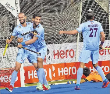  ?? HOCKEY INDIA ?? Ramandeep Singh (left) celebrates scoring India’s first goal in the Asia Cup final against Malaysia in Dhaka on Sunday.