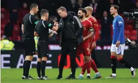  ?? Photograph: Andrew Milligan/PA ?? The Aberdeen manager, Barry Robson, speaks with officials after Rangers levelled through a late penalty.