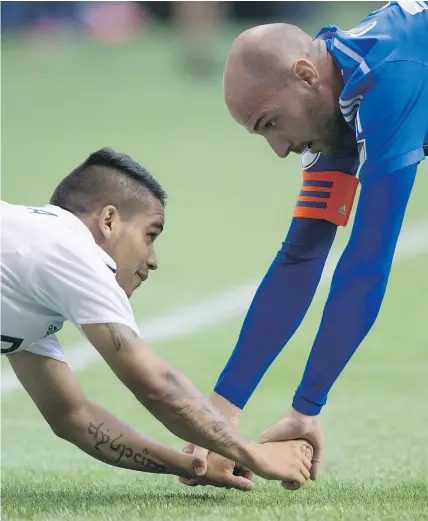  ?? — THE CANADIAN PRESS FILES ?? Montreal Impact’s Laurent Ciman, right, is now a member of the expansion LAFC franchise while Cristian Techera, left, remains with the Vancouver Whitecaps.