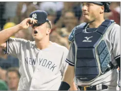  ?? Anthony J. Causi ?? SEVEN & HELL: Jonathan Holder, with catcher Austin Romine, reacts after giving up another run on his way to allowing seven runs without recording a single out.