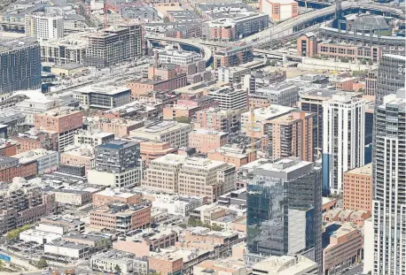  ?? RJ Sangosti, The Denver Post ?? Buildings in downtown Denver are seen from the air on Sept. 25. Up to 69 percent of the Mile High City is expected to be paved or covered by 2040. Denver ranks nearly last among major U.S. cities, including New York, in park space as a percentage of total area. Aerial support for this photo was provided by Lighthawk.