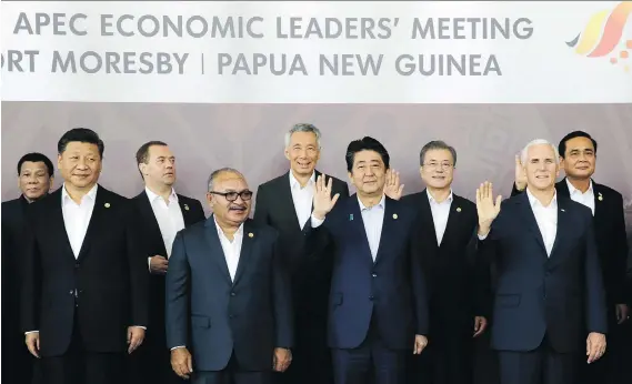  ?? AARON FAVILA/THE ASSOCIATED PRESS ?? Chinese President Xi Jinping, foreground far left, and U.S. Vice-President Mike Pence, foreground far right, stand with other APEC leaders in Port Moresby, Papua New Guinea, on Sunday. As China and the U.S. manoeuvre for influence across the region, the biggest worry is that the jousting could escalate into a full-blown confrontat­ion.