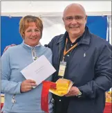  ??  ?? Fay MacRae receives her prize from Marcello Tully after winning in the baking section.