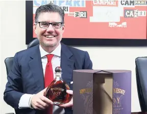  ?? PHOTO BY CHRISTOPHE­R SERJU ?? Campari Group chief executive officer Bob Kunze-Concewitz proudly poses with a bottle of the JOY Anniversar­y Blend Rare Jamaican Rum, special edition, produced by J. Wray & Nephew’s master blender Joy Spence, which sold out locally and internatio­nally...